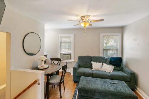 a living room with a couch and a table at Cozy 2 bed Apt 2 train stops to the Naval Base in Highwood