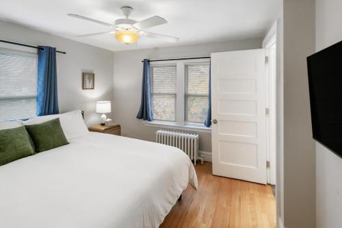 a bedroom with a white bed and a ceiling fan at USS Russell in Highwood