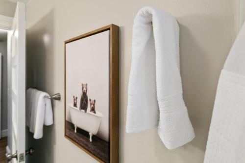 a bathroom with a mirror and towels on the wall at USS Russell in Highwood