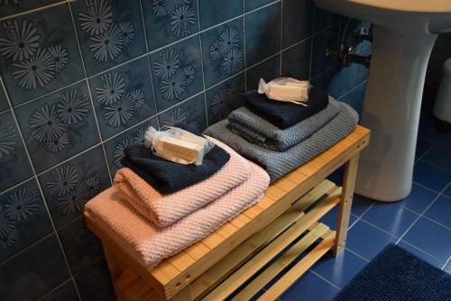 a pile of towels on a table in a bathroom at Ponte House in Piaia