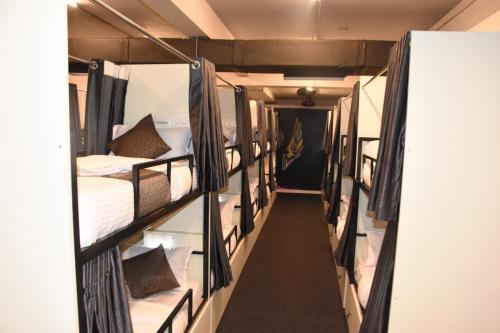 a row of bunk beds in a room at Ivory Inn Dormitory in Mangalore
