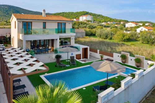 an image of a villa with a swimming pool at Masanda in Ždrelac