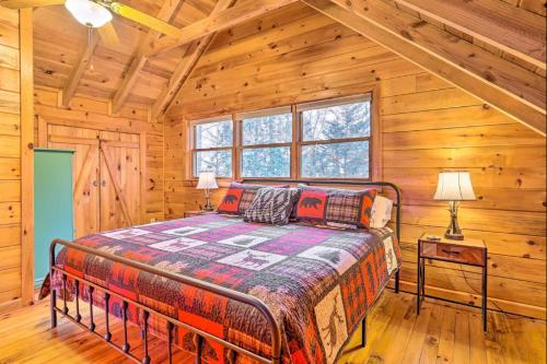 a bedroom with a bed in a log cabin at Sunrise Hideaway on Cherry Log Mountain in Blue Ridge