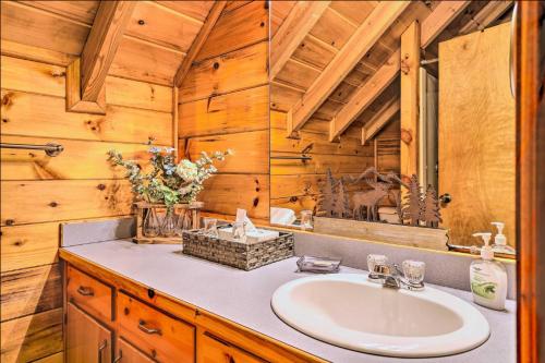 a bathroom with a sink in a wooden cabin at Sunrise Hideaway on Cherry Log Mountain in Blue Ridge