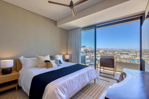 a bedroom with a large bed and a large window at Punto Nima, Spectacular Pool with Ocean View in San José del Cabo