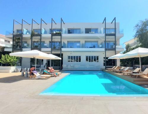 a swimming pool in front of a building at Mythical Sands - Orion in Protaras