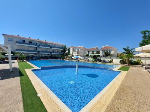 a large swimming pool in front of a building at Mythical Sands - Orion in Protaras