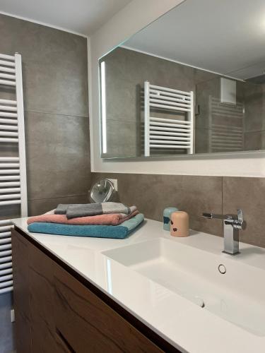 a bathroom with a sink and a mirror at ammersee apARTment Dießen in Dießen am Ammersee