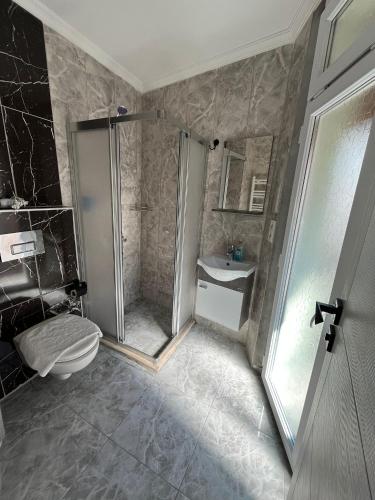 a bathroom with a shower and a toilet and a sink at Emirhan Inn Hotel, Sultanahmet in Istanbul