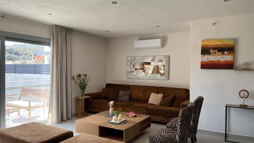 a living room with a couch and a table at Naiad Villa in Vari