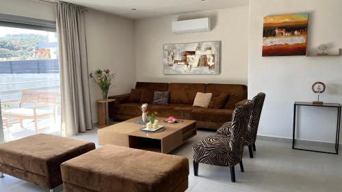 a living room with a couch and a table at Naiad Villa in Vari