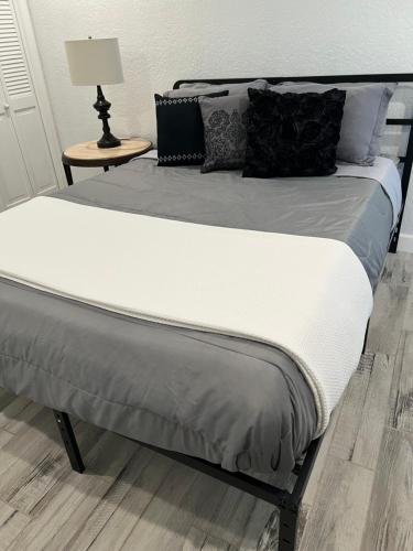 a bed with white sheets and pillows on it at Lakeside Sunset - Hot Tub, Pool Table, Beautiful Views!! in Canyon Lake