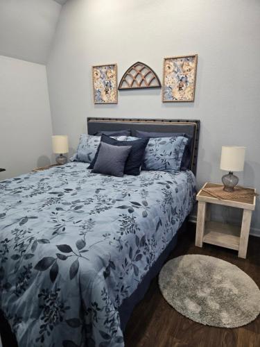 a bedroom with a bed with a blue comforter at The Blue Goose in Marshall