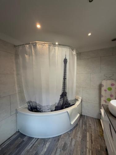 a bathroom with a shower with a eiffel tower at Homewood - entire property for 6 people - 4 adults maximum - in village 10 min from Disneyland Paris & TGV RER A in Montry