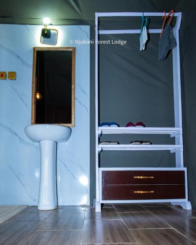 a bunk bed with a sink and a mirror at Njukiini Forest Lodge in Embu