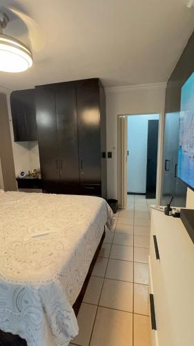 a bedroom with a bed and a tv in a room at The Urban Nest in Nelspruit