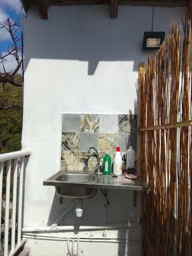 a sink on the side of a house with a wall at La plus grande source d'eaux chaudes F1 in Bouillante