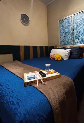 a tray sitting on top of two beds at Apartamento Reserva Sapiranga in Praia do Forte