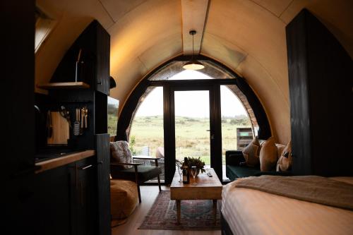 a room with a bed and a couch and a table at Wigtown by Wigwam Holidays in Newton Stewart