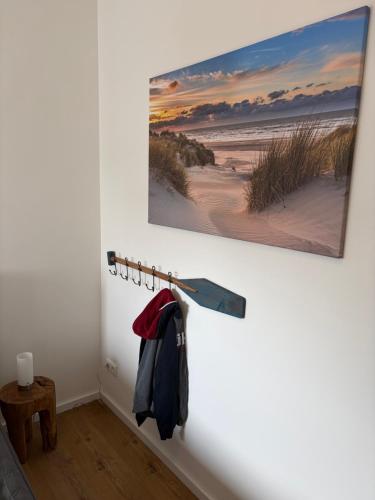 a room with a picture of the beach on the wall at Strandvilla GLOWE - Strandjuwel in Glowe