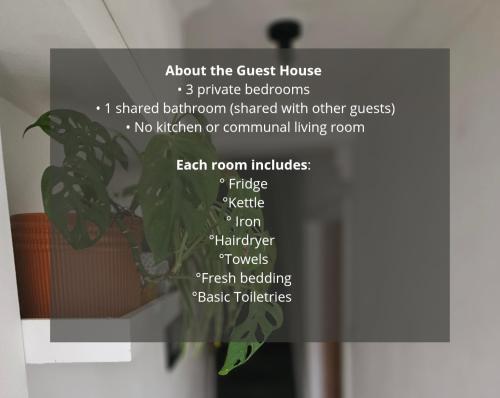 a sign with a plant in a room at Saint Margaret's Guest House - Comfortable Rooms in a Quiet Area Close to the Heart of Poole - Free Parking & Fast Wifi in Poole