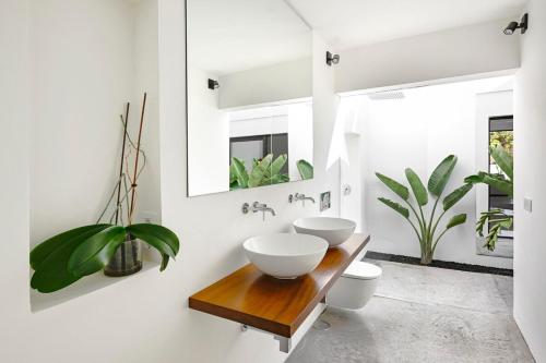 a bathroom with two sinks on a wooden table at Casa Abora - Ocean Views, Private Pool & Sunsets in La Pared