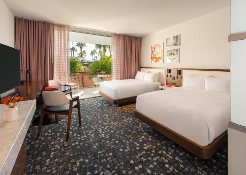 a hotel room with two beds and a desk at Hotel Valley Ho in Scottsdale