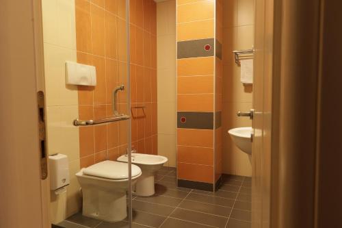 a bathroom with a toilet and a sink at Monun Boutique Hotel in Tirana