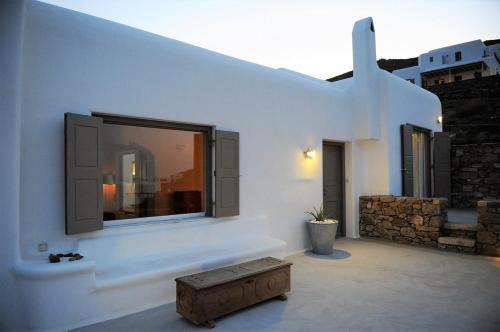 a white building with a tv on the wall at Mykonos Dunes Villas in Mikonos
