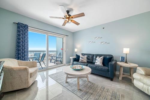 a living room with a couch and a ceiling fan at Caribbean Unit 103 in Gulf Shores