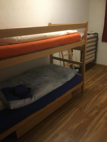 two bunk beds in a room with a wooden floor at Wohnung 17, Marico in Zermatt