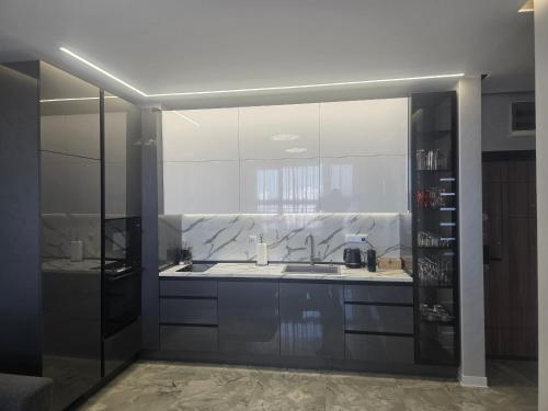 a kitchen with a sink and a large mirror at arena sunrise in Burgas