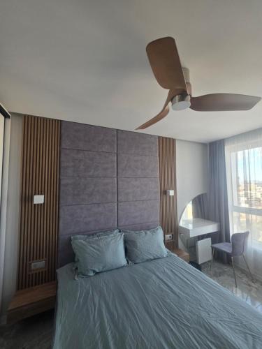 a bedroom with a bed with a ceiling fan at arena sunrise in Burgas
