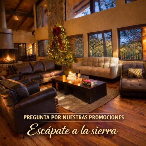 a living room with a christmas tree and leather furniture at Cabaña Santa Fe in Mesa de las Tablas