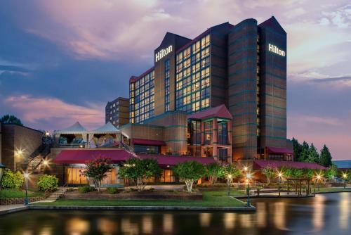 a rendering of a hotel at night at Hilton Charlotte University Place in Charlotte
