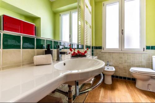 a bathroom with a white sink and a toilet at I Maltesi apartment in Sassari
