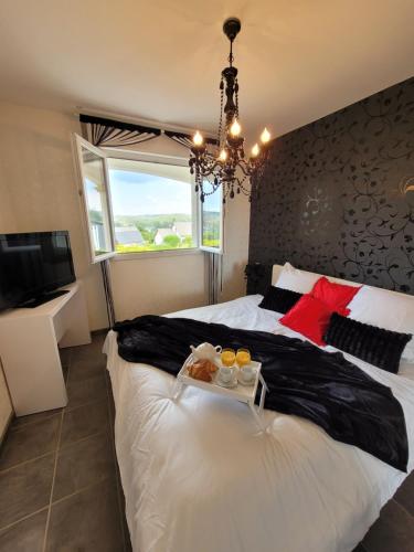 a bedroom with a bed with a tray of food on it at Haute-loire Tence Belle maison neuve plain-pied 4 étoiles avec parc arboré clos in Tence