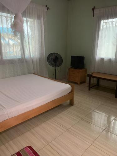 Katil atau katil-katil dalam bilik di Pension Le Cocotier