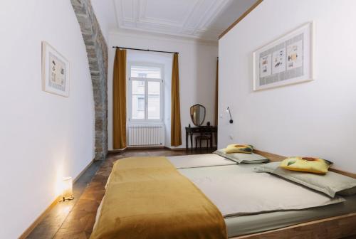 a bedroom with a large bed and a window at L'arco Trieste studio living 2 in Trieste