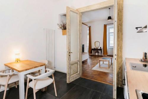 a large mirror in a dining room with a table and chairs at L'arco Trieste studio living 2 in Trieste