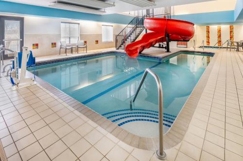 a swimming pool with a slide in a hotel room at Holiday Inn Express Hotel & Suites Loveland by IHG in Loveland