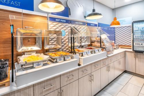 a fast food restaurant with food on display at Holiday Inn Express Hotel & Suites Loveland by IHG in Loveland