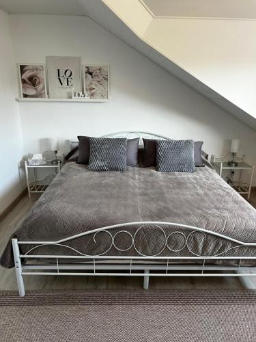 a bedroom with a large bed and two tables at Heimglück mit Ipf & Ruine in Bopfingen