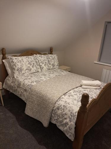 a bedroom with a bed with a white comforter at Reek View Accommodation in Westport