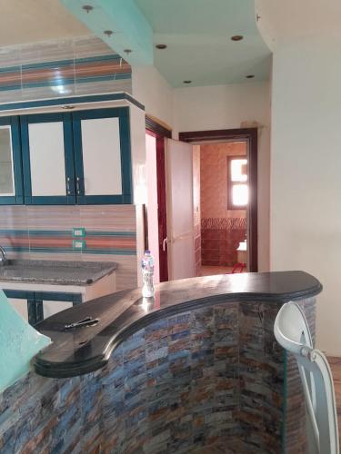 a kitchen with a counter with a bottle of water on it at El Basha Apartment sea View in Dumyāţ al Jadīdah