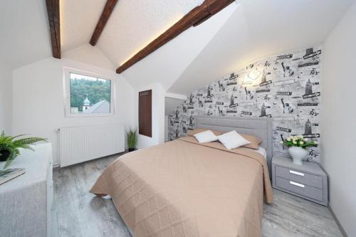 a bedroom with a bed and a wall covered in photographs at Residence Deluxe Benamino in Bran