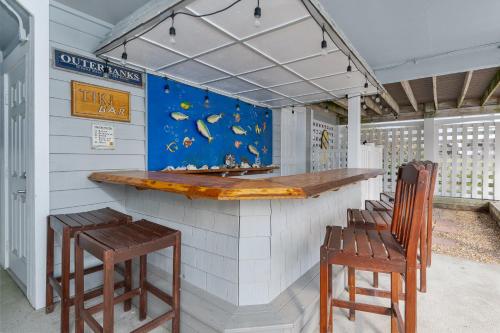 a bar with two stools and a counter with aitating at 4108 - New Beginnings in Duck