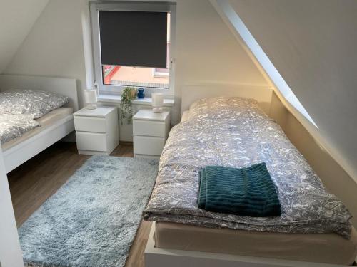 a small bedroom with a bed and a window at R&A Unterkunft in Oberhausen