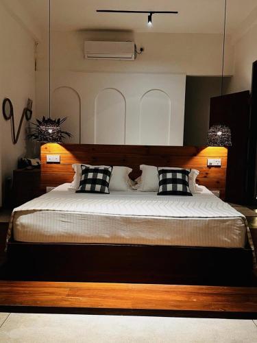 a bedroom with a large bed with black and white pillows at Celestine's Hideaway in Kamburugamuwa
