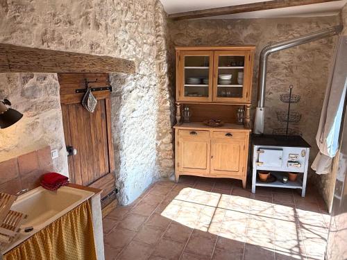 a kitchen with a sink and a stove at Le Logis - Maison authentique avec jardin et vue panoramique in Mons